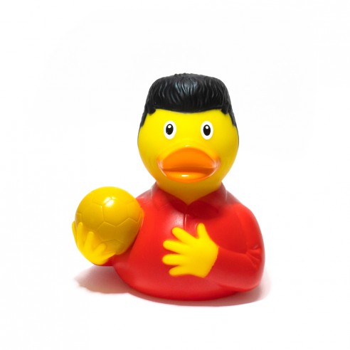 Pato de goma Balón de Oro, con peinado icónico, camiseta roja y un balón dorado en su mano.